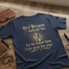 Christian t-shirt with gold text "Hey Person behind me, let me know how I can pray for you!" and praying
