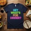 HEY WHAT'S FOR DINNER? text in neon colors on a navy t-shirt, with food items surrounding it