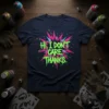 Neon green and pink "Hi, I DON'T CARE. THANKS." text graphic on a navy t-shirt
