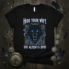 Black t-shirt with "Hide Your Wife The Alpha Is Here" text and a menacing blue-eyed black wolf graphic