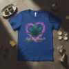 High Maintenance text with a green cannabis leaf inside a pink glowing heart on a blue t-shirt