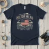 Navy blue t-shirt with "Hilton Head EST 1983" text, an American flag, palm trees, and ocean waves graphic