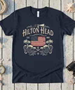 Navy blue t-shirt with "Hilton Head EST 1983" text, an American flag, palm trees, and ocean waves graphic