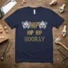 Navy blue t-shirt with "Hip Hip Hip Hooray" text and anatomical hip graphics in gold and white