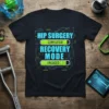 Black t-shirt with "Hip Surgery Completed Recovery Mode Engaged" text in tech-style font and progress bars
