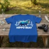Blue t-shirt with "HIPPO BEAT" text and a graphic of a hippo with a heartbeat line