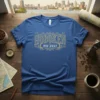 Blue t-shirt with vintage-style "Hoboken New Jersey" text in gold and white