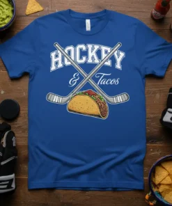 Blue t-shirt with white text "HOCKEY & Tacos" above crossed hockey sticks and a taco graphic