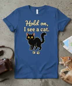Black cat graphic t-shirt with text "Hold on, I see a cat." and paw prints