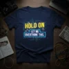 Navy blue t-shirt with yellow and neon blue text that reads "HOLD ON LET ME OVERTHINK THIS." Design features circuit