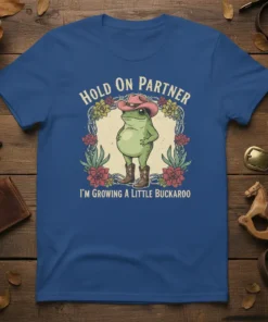 Frog wearing cowboy hat and boots with text "Hold On Partner I'm Growing A Little Buckaroo" T-Shirt
