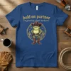 Hold On Partner I'm Growing A Little Buckaroo t-shirt with a frog cowboy graphic