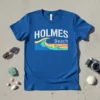 Blue t-shirt with white "HOLMES" text above a colorful wave graphic and "Beach" text, representing Holmes Beach vacation