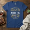 Home Is WHERE THE Love Is IS quote in gold and white script and block letters, framed by a laurel