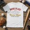 White t-shirt with "Home Plate Social Club Pitches Be Crazy" text, baseball player graphics, and baseballs