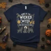 Home of the Wicked Witch and Her Pack of Dogs t-shirt with Halloween graphics and dog silhouettes