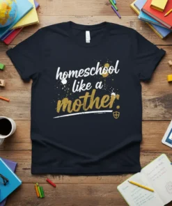 Homeschool like a mother quote on a dark navy t-shirt, with white and gold splattered text and a shield icon