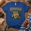 Honduras Jaguar T-Shirt featuring a detailed jaguar face surrounded by tropical leaves and flowers, with "HONDURAS" text above