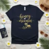 Navy t-shirt with "honey moonin" in gold glitter text and a tropical beach graphic with palm trees and wedding rings
