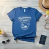 Blue t-shirt with "Honeymoon Cruise 2024 2024" text and a circular graphic of a cruise ship, palm tree, and waves