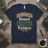 Honored Blessed Creative Unique quote on a navy t-shirt with gold, white, and green lettering and a laurel wreath graphic