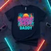 Hoochie Daddy Daddy text with retro 80s beach sunset and palm trees graphic on a navy t-shirt