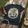 Hootin' Leads to Hollerin' t-shirt design featuring an owl cowboy riding a horse with western stars and text