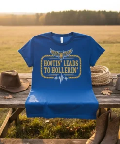 Blue t-shirt with "Hootin' Leads To Hollerin'" text and owl graphic, featuring a heartbeat line below the quote