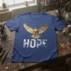 HOPE EAGLE DESIGN T-Shirt with a golden eagle graphic above the word HOPE in distressed white text