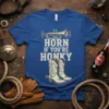 Horn If You're Honky t-shirt with a trumpet graphic and cowboy boots, featuring distressed text in cream and yellow