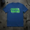 Blue t-shirt with "HOSTILE WORKPLACE" in neon green and blue distressed text, surrounded by barbed wire and hazard symbols