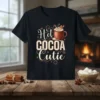 Hot Cocoa Cutie text design with a steaming mug of hot chocolate, marshmallows, candy cane, and gingerbread cookie