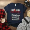 HOT COCOA FLANNEL and Christmas MOVIES MOVIES text design on a navy t-shirt, featuring festive graphics and holiday theme