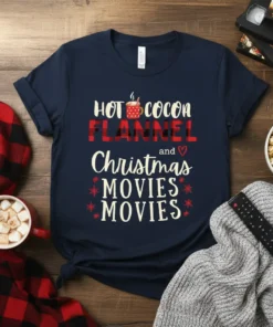 HOT COCOA FLANNEL and Christmas MOVIES MOVIES text design on a navy t-shirt, featuring festive graphics and holiday theme