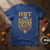 Hot Like Bajan Pepper Sauce t-shirt design with yellow text and chili pepper graphics