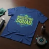 Housekeeping Squad text design in bright green and teal on a navy blue t-shirt, featuring geometric shapes
