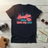 Houston Girls Girls trip 2023 text with neon outline and cityscape graphic on a navy t-shirt
