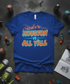 Royal blue t-shirt featuring "Houston Vs All Y'All" in orange and teal graffiti-style font with a city skyline graphic above