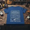 T-shirt with the text "HOW MANY GUITARS DO I REALLY NEED? JUST ONE MORE" surrounded by various guitar illustrations and