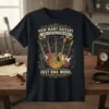 How Many Guitars Does A Guitar Player Need? Just One More. text on a t-shirt with multiple guitars and musical