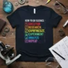 T-shirt with "How To Do Science" steps: Question, Research, Expothesize, Experiment, Analyze, Repeat in colorful text and icons