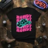 Black t-shirt with repeated pink "HOWDY" text and a central neon turquoise cowboy hat with stars graphic