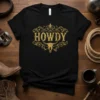 Black t-shirt with distressed gold "Howdy" text and a bull skull graphic, perfect for western wear enthusiasts