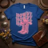 Blue t-shirt with pink "Howdy Howdy Howdy Ho" text and pink cowboy boots graphic