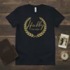 Hubby -EST 2023- text inside a gold laurel wreath on a black t-shirt, commemorating a new marriage