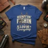 Huntin' Fishin' & Lovin' Everyday text design with deer antlers, bass fish, and crossed rifles graphic on a blue t-shirt
