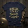 Husband Dad Drummer Legend text design on a navy t-shirt with drumsticks graphic