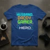 Husband Daddy Gamer Hero text design with gaming icons and futuristic circuit elements on a blue t-shirt