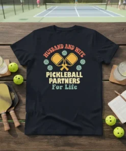 Husband and Wife Pickleball Partners For Life text with pickleball paddles and balls graphic on navy t-shirt