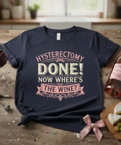 Hysterectomy Done! Now Where's The Wine? text design with pink and yellow vintage-style lettering on a navy blue t-shirt